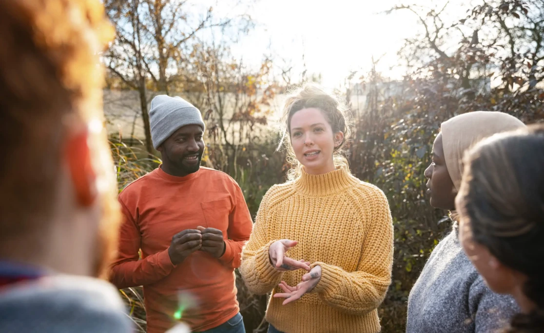People gathered round talking in a garden