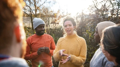 People gathered round talking in a garden