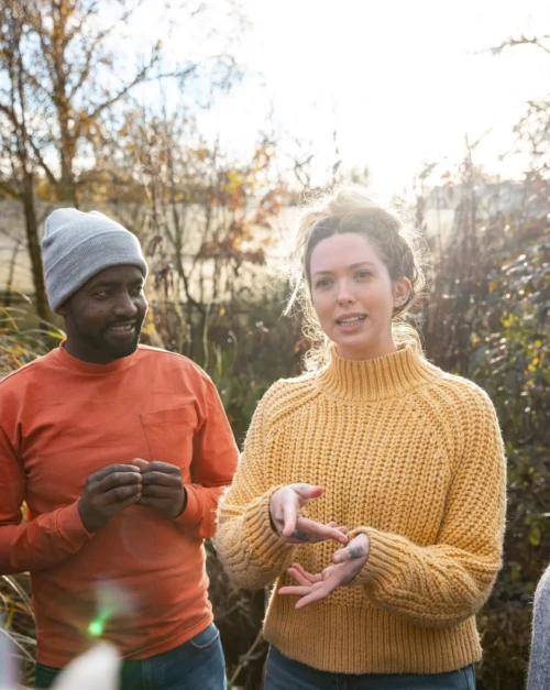People gathered round talking in a garden